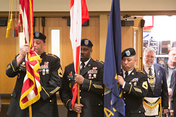 Photo of presentation of the flags. Link to What to Give.