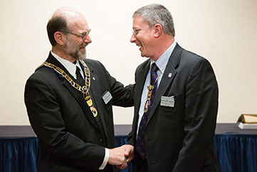 Photo of two men shaking hands. Link to Gifts by Estate Note.