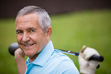 Photo of a man with a golf club. 