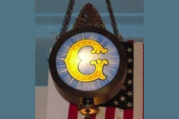 Photo of lit up 'G' sign. Link to Gifts of Cash, Checks, and Credit Cards.